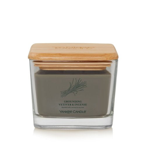 Yankee Candle Well Living Medium Grounding Vetiver & Incense in a stylish square glass jar with a natural wooden lid, emitting a calming earthy fragrance.
