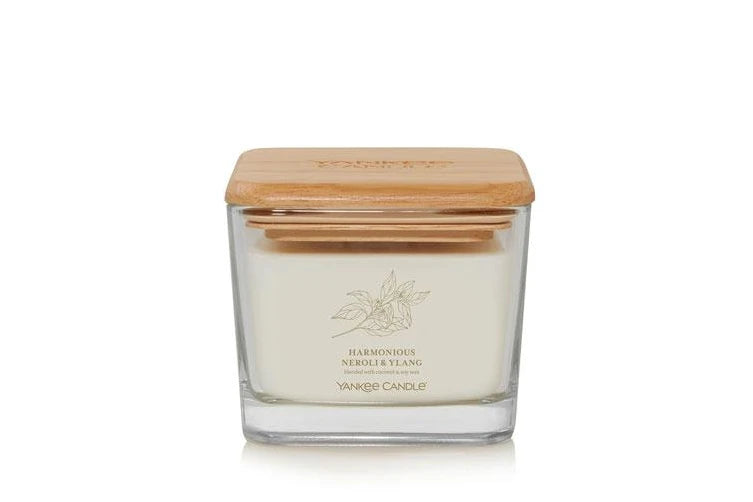 Yankee Candle Well Living Medium Harmonious Neroli & Ylang in a stylish square glass jar with a natural wooden lid, emitting a calming floral fragrance.
