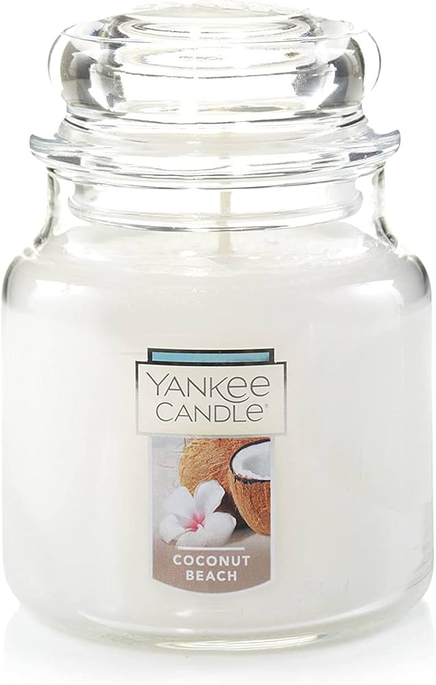 Yankee Candle Medium Jar in Coconut Beach scent, featuring a classic glass jar with dome lid, emitting a soothing tropical fragrance.
