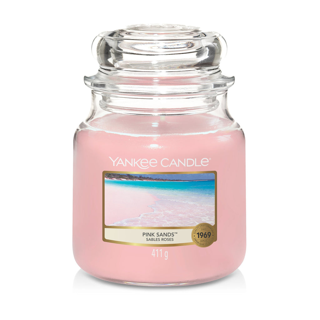 Yankee Candle Medium Jar in Pink Sands scent, featuring a classic glass jar with dome lid, emitting a refreshing and invigorating fragrance.
