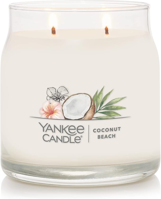 Yankee Candle Signature Medium Jar in Coconut Beach scent, featuring a classic glass jar with lid, emitting a warm coconut and pineapple fragrance.
