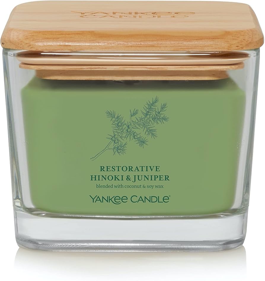 Yankee Candle Well Living Medium Restorative Hinoki & Juniper in a stylish square glass jar with a natural wooden lid, emitting a serene woody and juniper fragrance.
