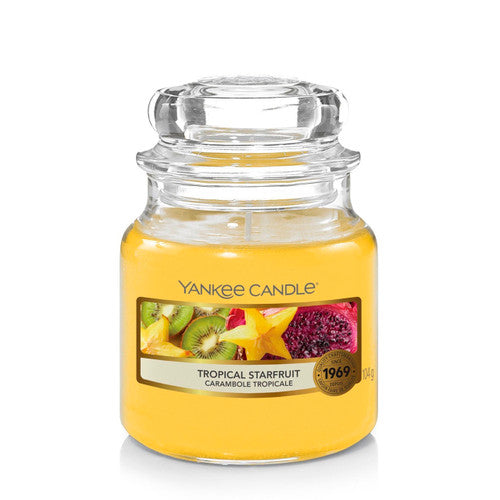 Yankee Candle Small Jar in Tropical Starfruit scent, featuring a classic glass jar with dome lid, emitting a vibrant and refreshing tropical fragrance.
