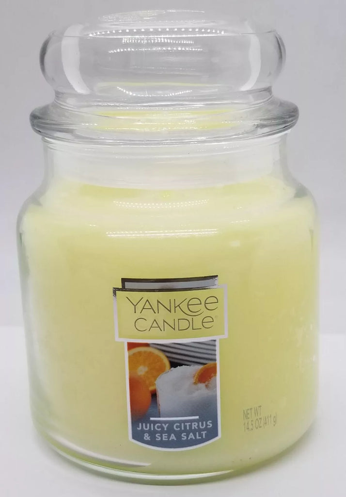 Yankee Candle Medium Jar in Juicy Citrus & Sea Salt scent, featuring a sleek glass jar with brushed metal lid, emitting a refreshing citrus and sea breeze fragrance.
